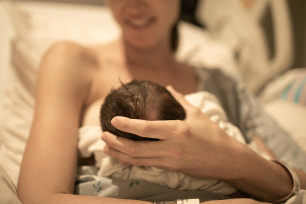 Mother holding her newborn baby in the hospital.